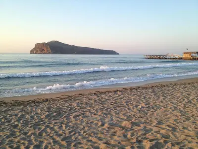 a sandy beach with a view of the ocean at Angelica Studios and Apartments in Agia Marina Nea Kydonias