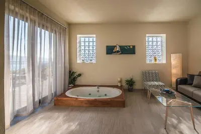 a living room with a tub in the middle of a room at Istros Villas - with Pools, BBQ & Heated Spa Whirlpools, By ThinkVilla in Korakiaí