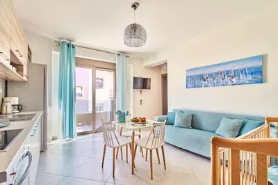 a living room with a blue couch and a table at Lydia's Apartments in Kissamos