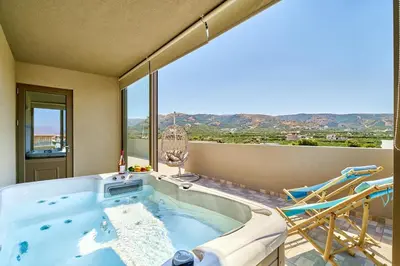 a jacuzzi tub in a room with a view at Lydia's Apartments in Kissamos