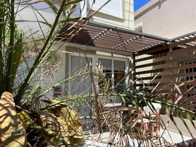 a house with a window and some plants at Artemis Rooms two steps by the sea in Plataniás