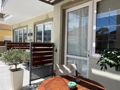 a dining room with a table and a window at Artemis Rooms two steps by the sea in Plataniás