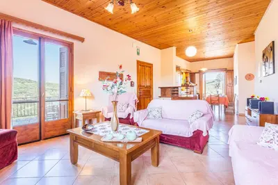 a living room with a bed and a table at Olive Villas in Kría Vrísi