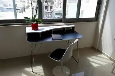 a desk and a chair in a room with a window at Heart City Executive Suite in Chania Town