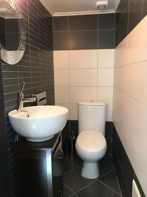a bathroom with a white toilet and a sink at Heart City Executive Suite in Chania Town