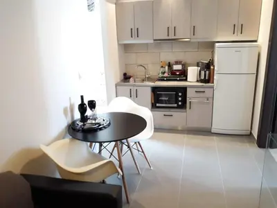 a small kitchen with a table and white appliances at Heart City Executive Suite in Chania Town