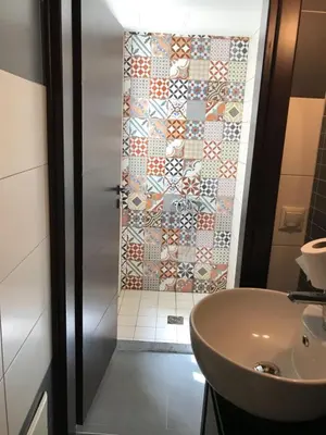 a bathroom with a shower and a white sink at Heart City Executive Suite in Chania Town