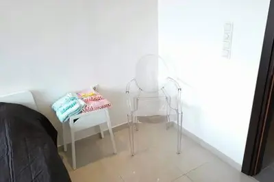 a room with a chair and a table in a room at Heart City Executive Suite in Chania Town