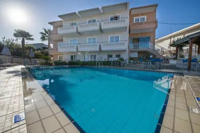 a large swimming pool in front of a building at Dias Hotel Apartments in Agia Marina Nea Kydonias
