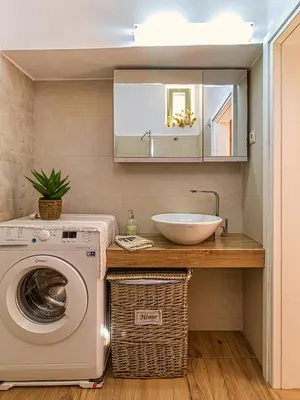 a bathroom with a washing machine and a sink at Antonia Traditional Estate in Chania Town