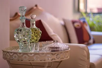 two bottles and glasses on a table in front of a couch at Antonia Traditional Estate in Chania Town