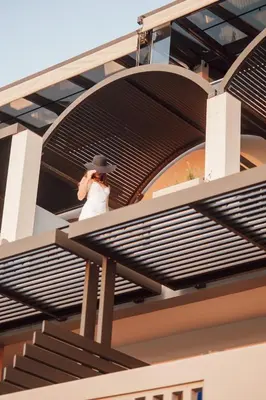 a woman walking up the stairs of a building at Royal Sun in Chania Town