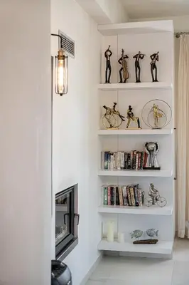 a living room with white shelves with bikes on them at Villa Aloni in Kissamos