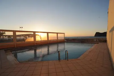 a swimming pool on a building with the ocean in the background at Georgina in Agia Marina Nea Kydonias