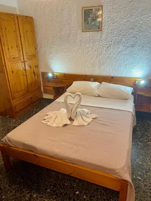 a bed with two swans sitting on top of it at Lefka in Kolymvari