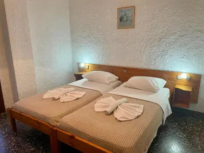 two beds in a room with towels on them at Lefka in Kolymvari
