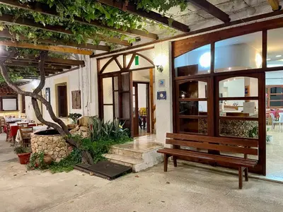 a building with a bench in front of a building at Lefka in Kolymvari