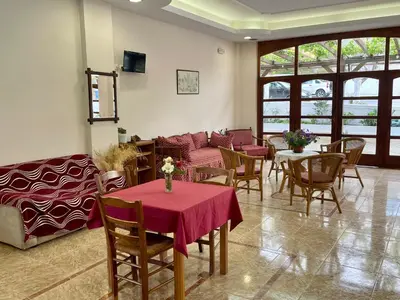 a living room with a table and chairs and a couch at Lefka in Kolymvari