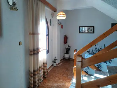 a hallway with a staircase and a window in a house at Lefka in Kolymvari