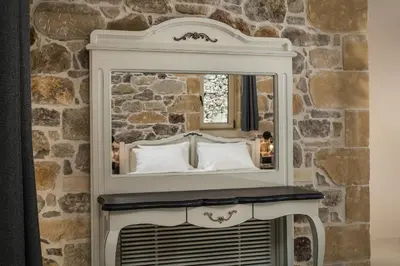 a mirror on top of a table with a fireplace at Villa Antonousa - Private Pool Oasis in Kerá