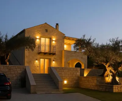 a house with a staircase in front of it at night at Villa Antonousa - Private Pool Oasis in Kerá