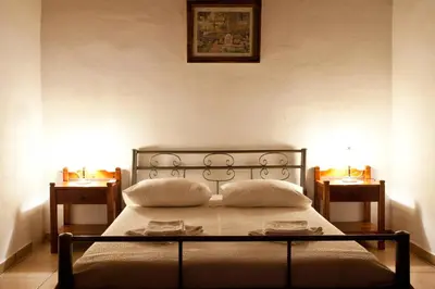 a bedroom with a bed with two pillows on it at Tsivaras Villas in Tsivarás