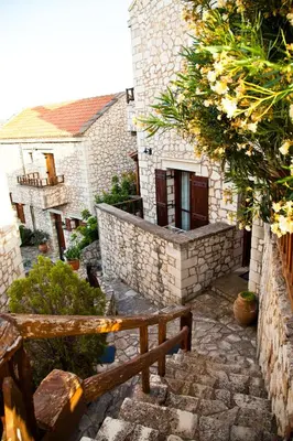an outside view of a stone building with a bench at Tsivaras Villas in Tsivarás