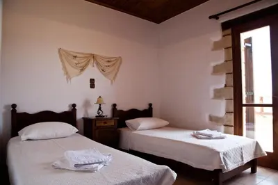a bedroom with two beds and a window at Tsivaras Villas in Tsivarás