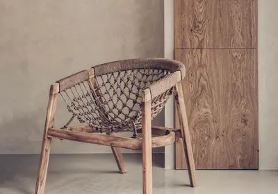 a rattan chair sitting in front of a cabinet at Monastery Estate Retreat in Sougia