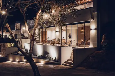 a house with lights on the side of it at Monastery Estate Retreat in Sougia