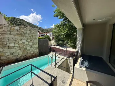 a view of a swimming pool from a house at Monastery Estate Retreat in Sougia