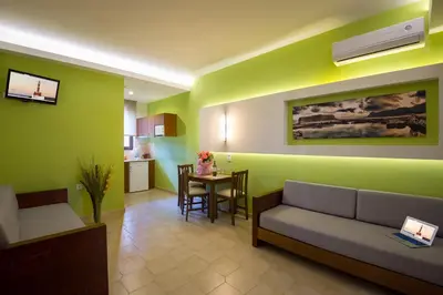 a living room with a couch and a table at Oscar Suites & Village in Agia Marina Nea Kydonias