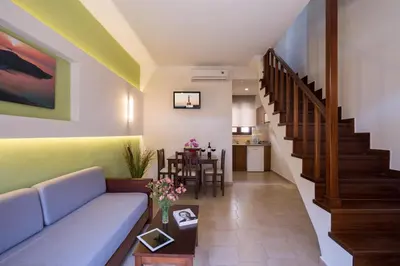 a living room with a couch and a table at Oscar Suites & Village in Agia Marina Nea Kydonias