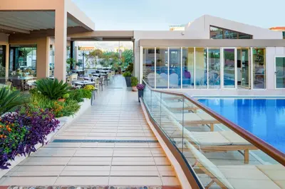 a view of a building with a swimming pool at Oscar Suites & Village in Agia Marina Nea Kydonias