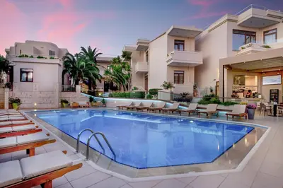 a pool at a hotel with chairs and tables at Oscar Suites & Village in Agia Marina Nea Kydonias