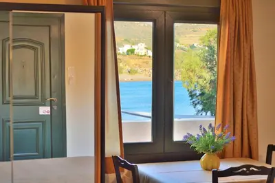 a dining room with a table and a window at Maria Beach Hotel in Kissamos