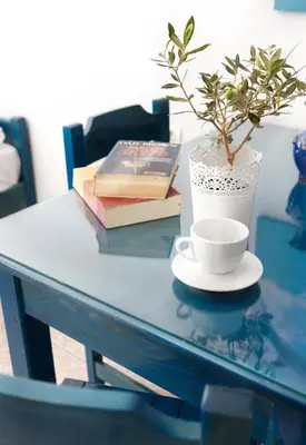 a table with a plant and a cup and books at Sun Nicolas in Kato Daratso