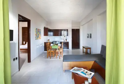 a living room with a couch and a kitchen at Sun Nicolas in Kato Daratso