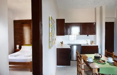 a kitchen with a bed and a table in a room at Sun Nicolas in Kato Daratso