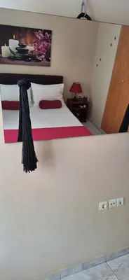 a bedroom with a large white bed with pink sheets at Modern Apartment Chania Center in Chania Town