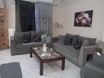 a living room with two couches and a coffee table at Modern Apartment Chania Center in Chania Town