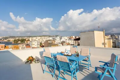 a blue table and chairs on a roof at Sea View Penthouse with Roof Garden in Chania Town