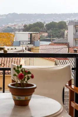 a flower in a pot sitting on a table on a balcony at Sea View Penthouse with Roof Garden in Chania Town