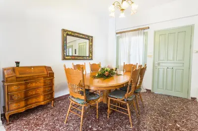 a dining room with a table and chairs and a mirror at Sea View Penthouse with Roof Garden in Chania Town
