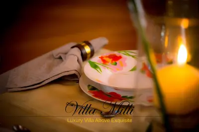 a table with a candle and a cup with flowers on it at Villa Milli in Chania Town