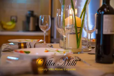 a table with wine glasses and a bottle of wine at Villa Milli in Chania Town
