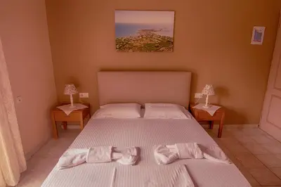 a bedroom with two beds with towels on them at Oriental Bay in Palaiochóra