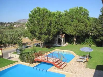 an aerial view of a swimming pool with a house at Vamos Palace Apartments in Vamos