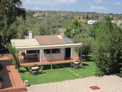 a house with a patio with tables and chairs at Vamos Palace Apartments in Vamos