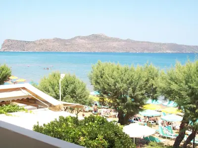 a view of the beach from the balcony of a resort at Kato Stalos Beach in Stalos